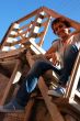 attractive girl sitting on wooden stairs