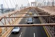 Traffic moving under Brooklyn bridge New York