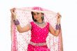 Beautiful Bangali bride lifting veil