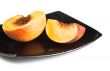 red peaches slices on black dish
