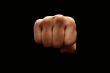 A manï¿½s fist isolated on black background