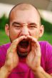 Closeup of a young man screaming