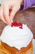 Hands decorating christmas cake