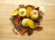 Three apples in autumn leaves